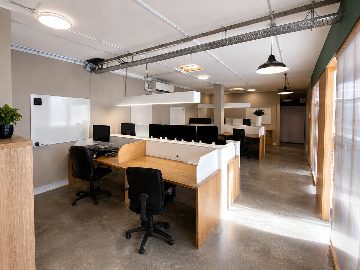 Open plan coworking space with dedicated desks at Lyall Bay WorkHub Wellington